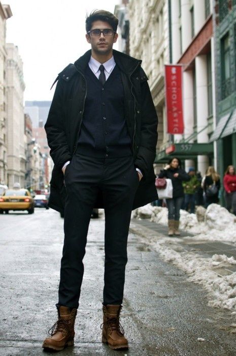 a black look with a white shirt and brown boots for a statement .